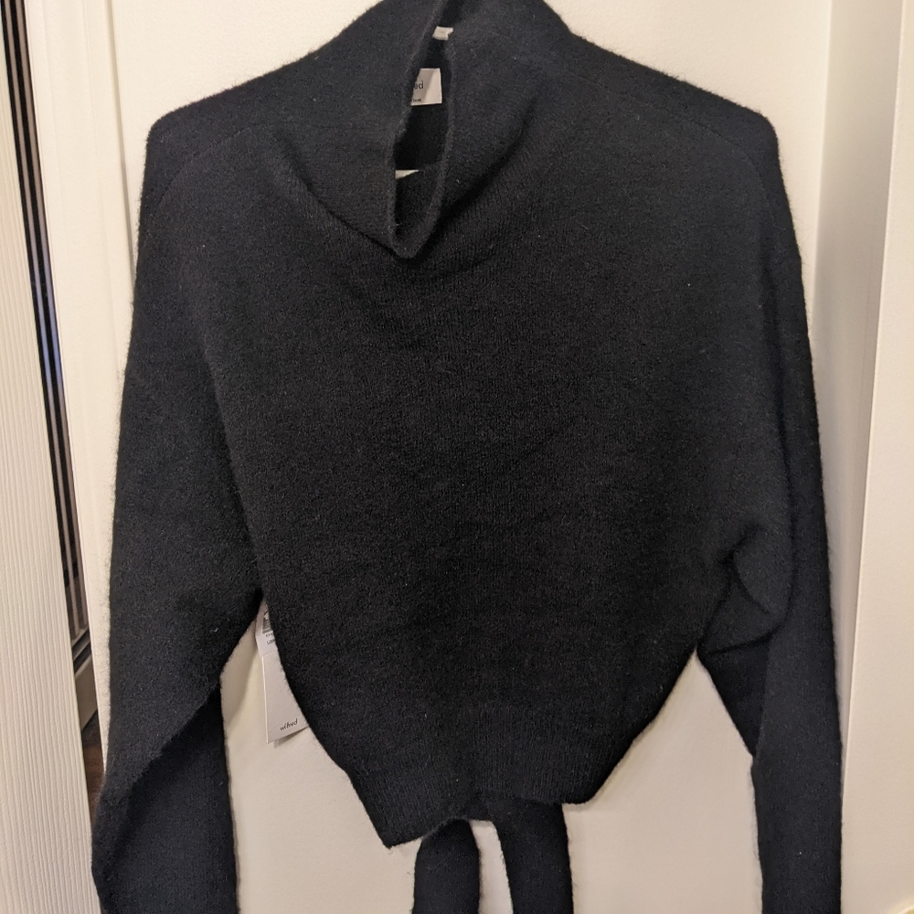 Black mockneck sweater with tie.